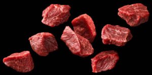 Raw beef meat pieces isolated on white background with clipping path